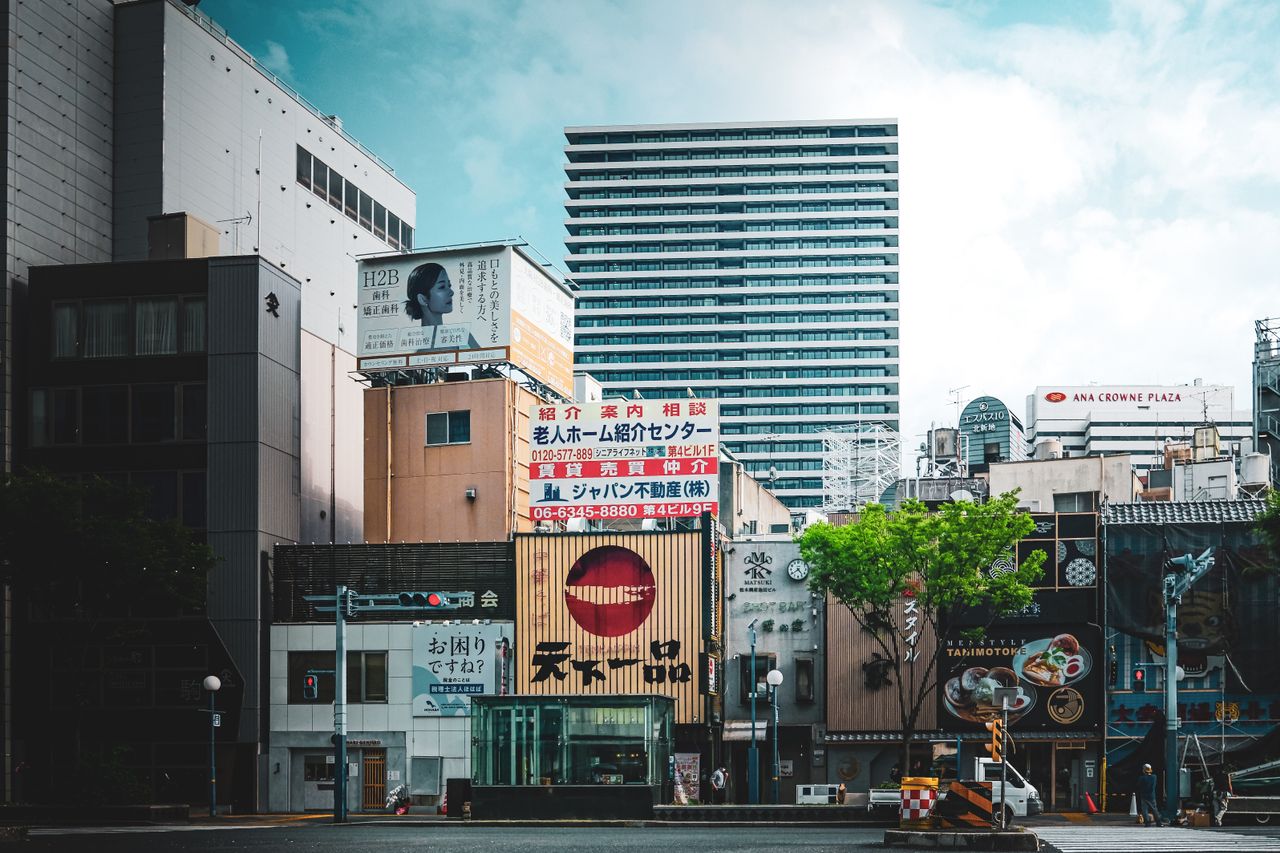 vibrant city view with modern architecture and advertisement signs sho