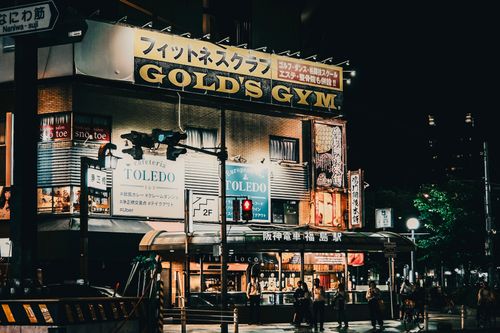 Free Vibrant night scene of Gold's Gym and Cafeteria Toledo in Tokyo, Japan with city lights and signage. Stock Photo