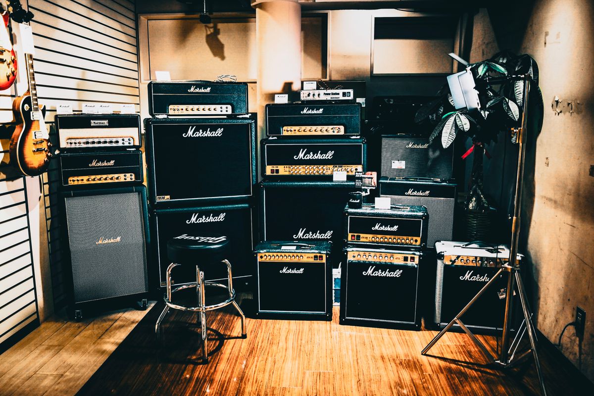 Row of full-size Marshall amplifier stacks in a music shop