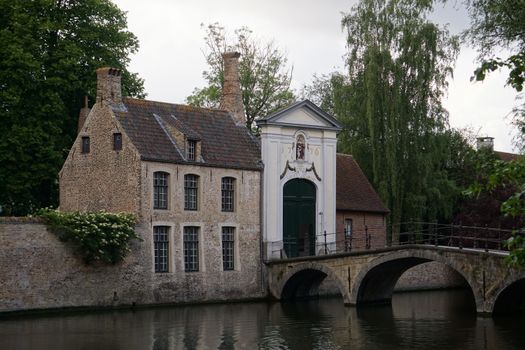 Pre-dawn canal row with a photographer — Bruges