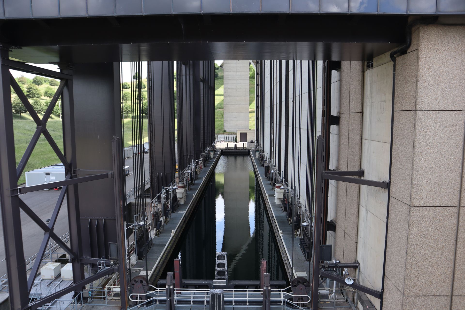 View of a boat lift with concrete structures and water channel, illustrating industrial engineering.