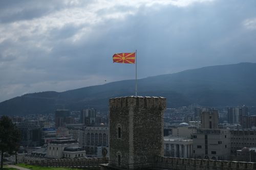 Free View of Skopje Castle with the Macedonian flag flying high above the cityscape. Stock Photo