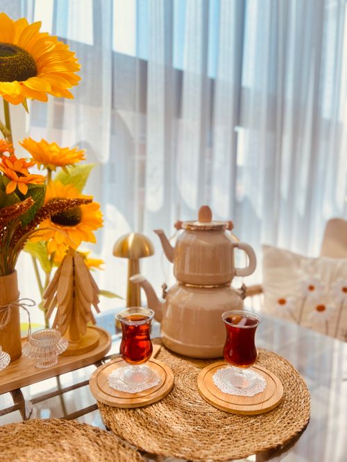 Free Warm indoor scene of Turkish tea with sunflowers and cozy decor. Stock Photo