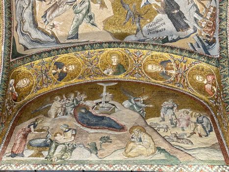 Beautiful Byzantine mosaic art depicting religious scenes in historic chapel.