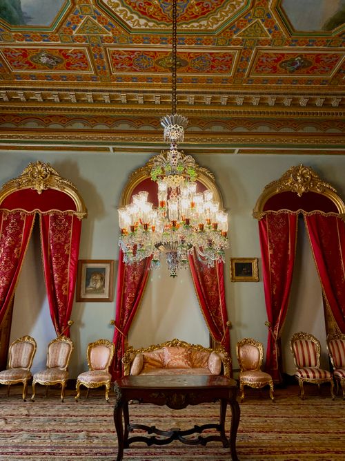 Free Elegant Baroque style room featuring a grand crystal chandelier, ornate furniture, and decorative ceilings. Stock Photo