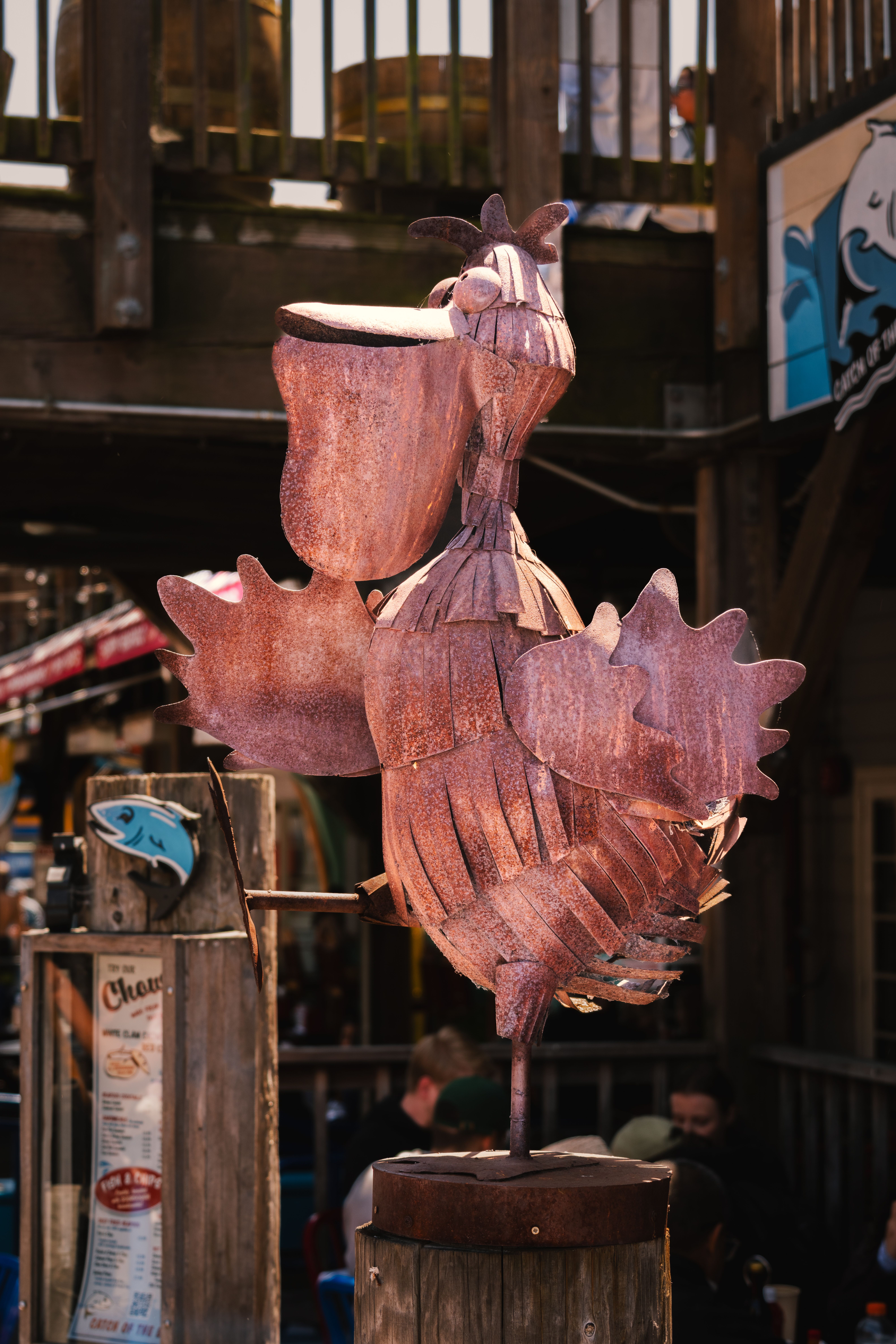 Metal pelican sculpture at San Francisco's Pier 39 with a nautical backdrop.