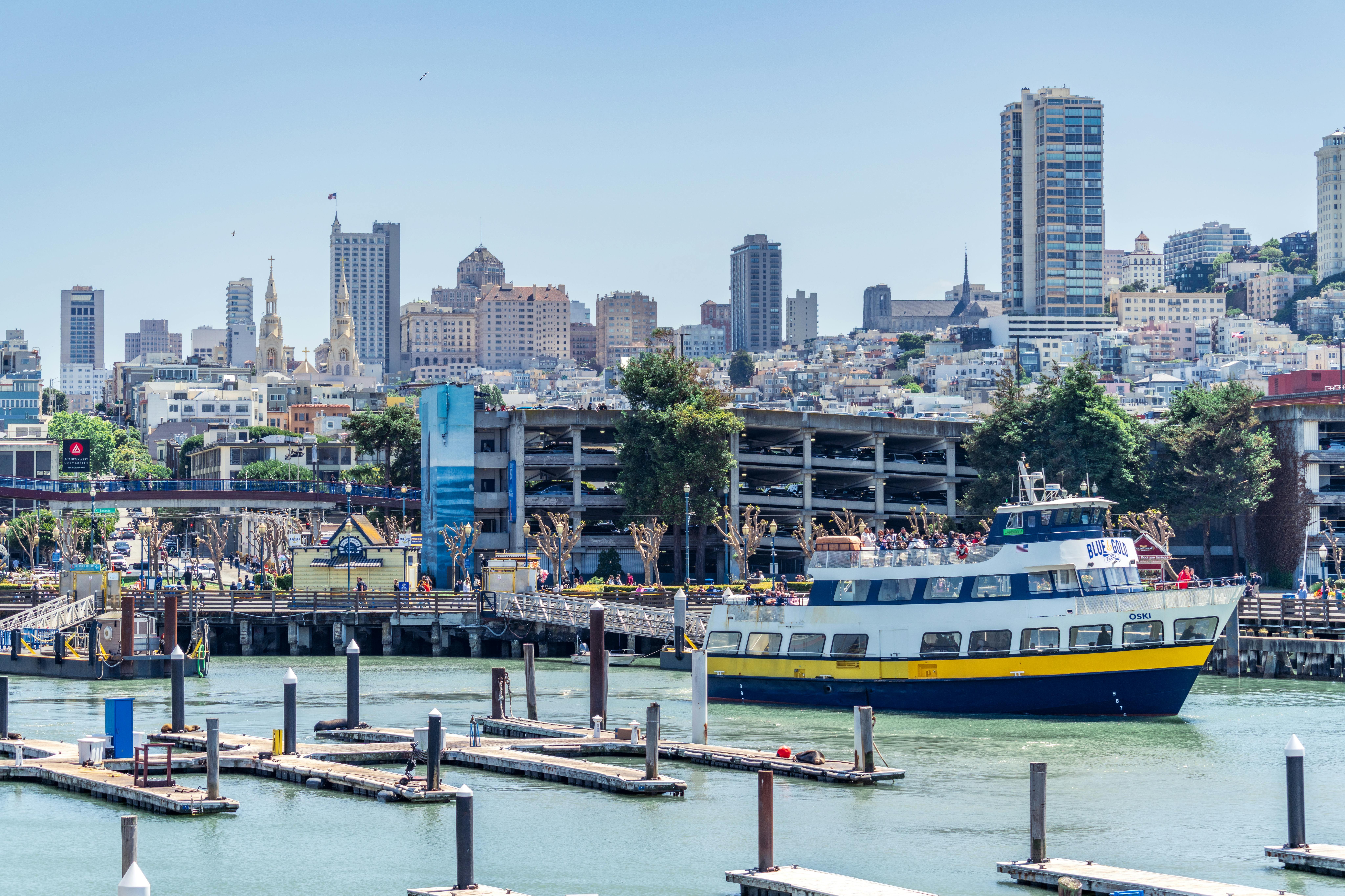 Beautiful view of San Francisco skyline with ferry and Pier 39 in the foreground.