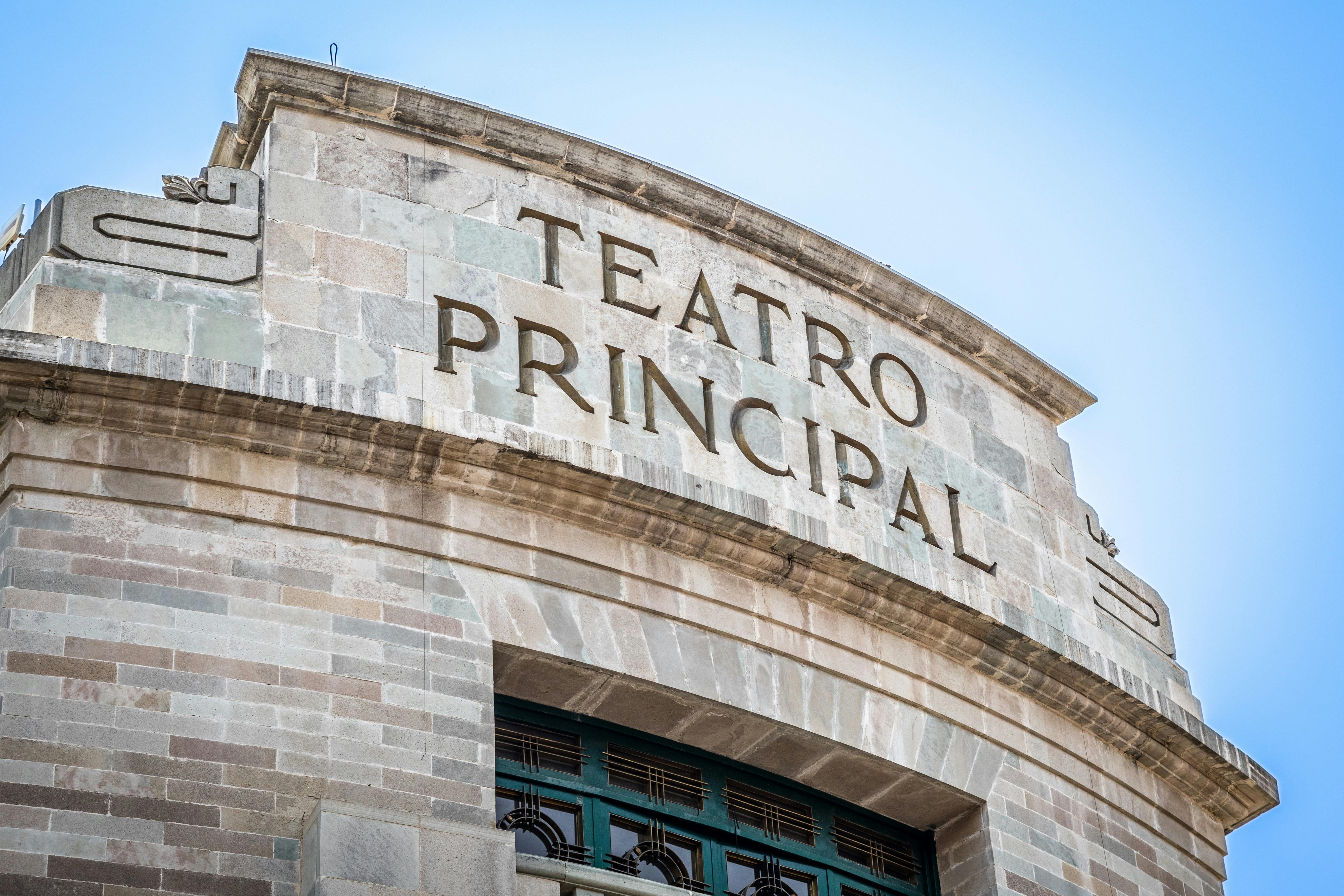 Free Stone facade of Teatro Principal with clear blue sky backdrop, classic architectural style. Stock Photo