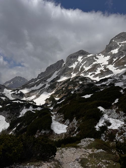 Free Dramatic view of snow-covered mountains in Slovenia under a cloudy sky. Stock Photo
