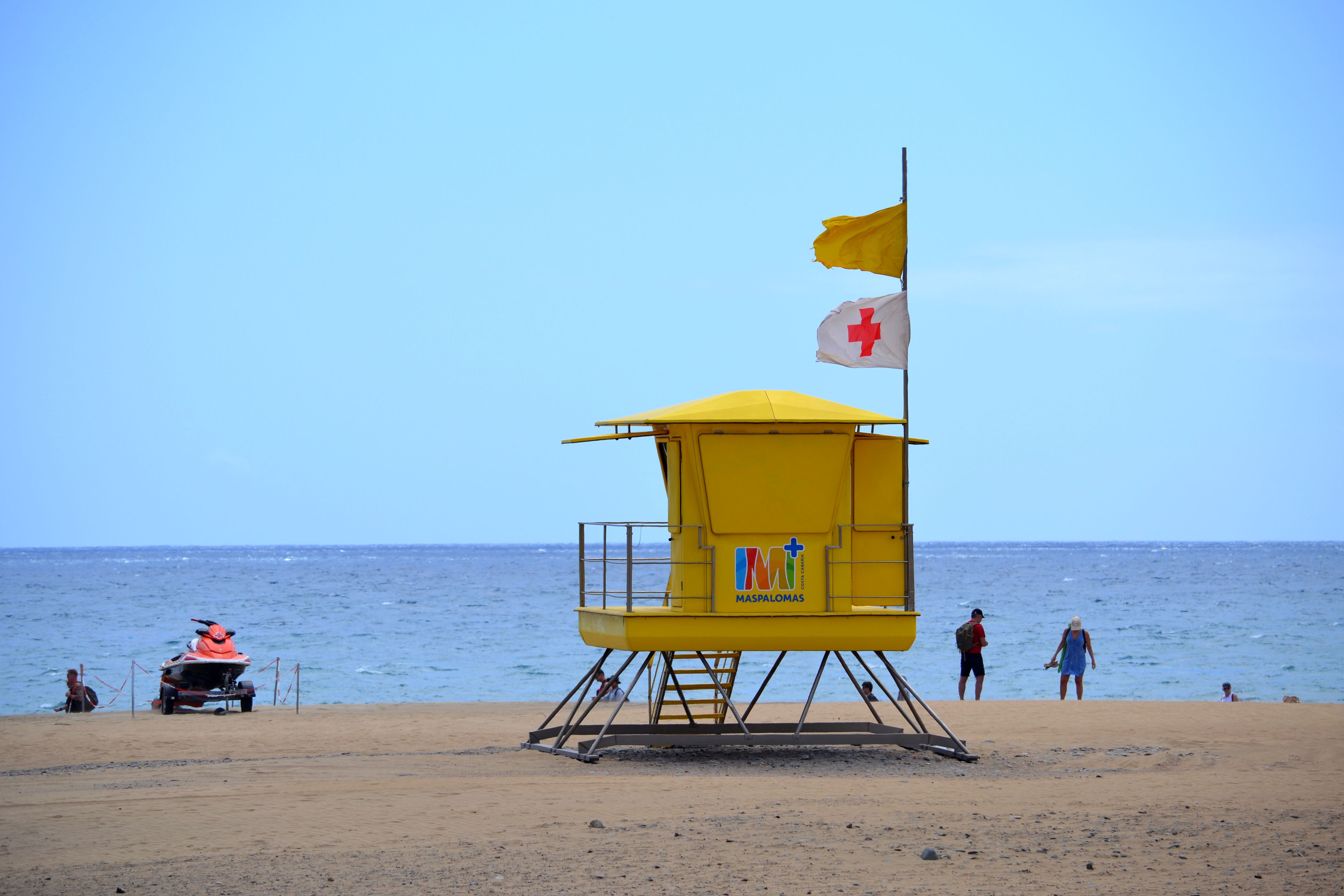 lifeguard tower beach red cross flag
