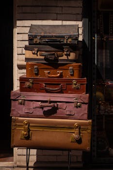 A stack of vintage suitcases outside on a bright day. Nostalgic travel concept.