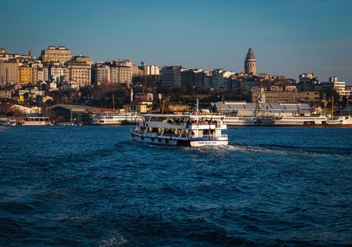 Free Scenic view of a ferry cruising on the Bosphorus in Istanbul with the iconic Galata Tower in the background. Stock Photo