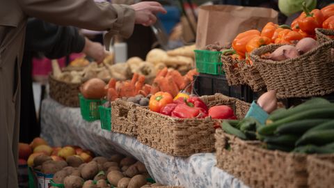 Fresh vegetables on display at a bustling Toronto farmers market, highlighting vibrant colors and local produce.