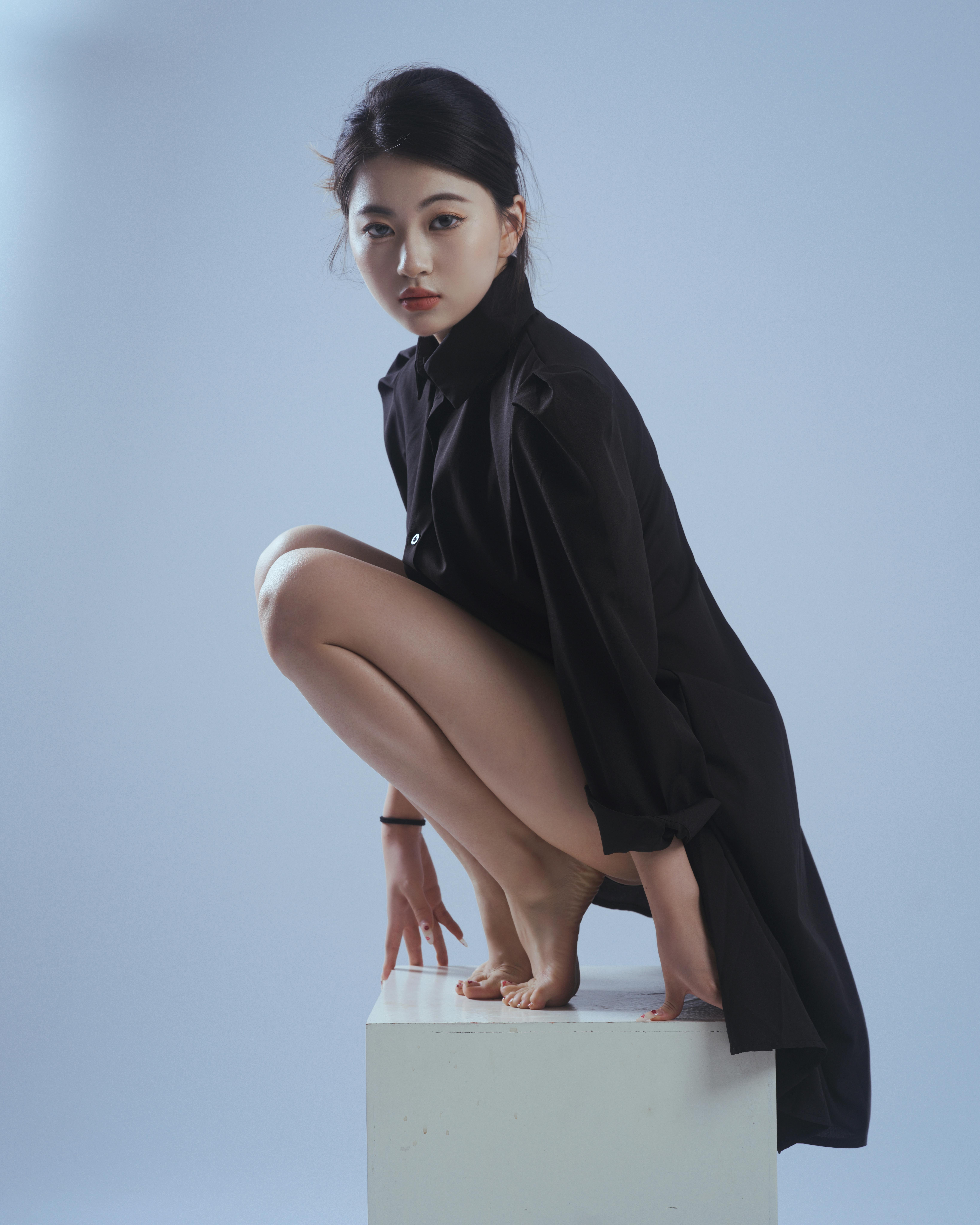 Free Elegant portrait of a woman in a black dress and thoughtful pose, studio shot Stock Photo