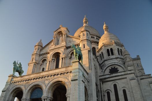 The stunning Sacre Coeur Basilica captured with its iconic domes at sunset in Paris, France.