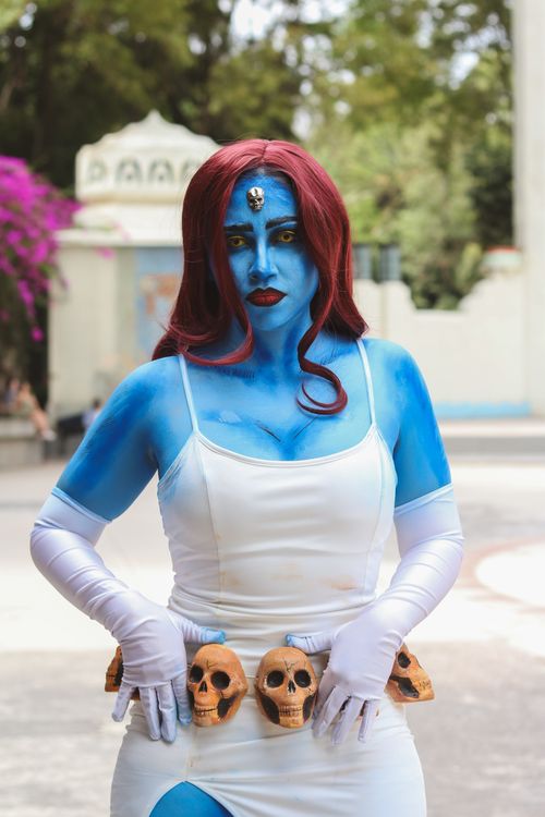 Blue-Skinned Cosplayer with Skulls Belt Outdoors · Free Stock Photo