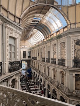 Beautiful indoor market in Istanbul featuring classical architecture and an arched glass ceiling.