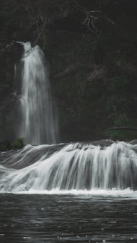 Peaceful waterfall cascading through lush greenery in Villa La Angostura, Argentina.