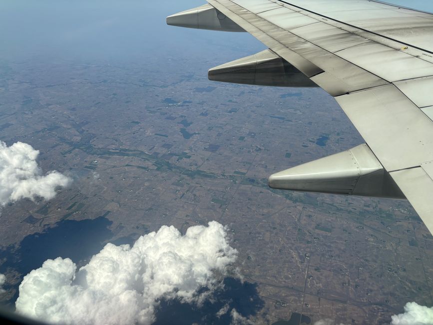 Outstanding Family Pack 48 Miles Helicopter Tour over Theme Parks & Downtown Review 2026 - Aerial shot of Minnesota farmland captured from an airplane with clouds below, showcasing agricultural landscape.
