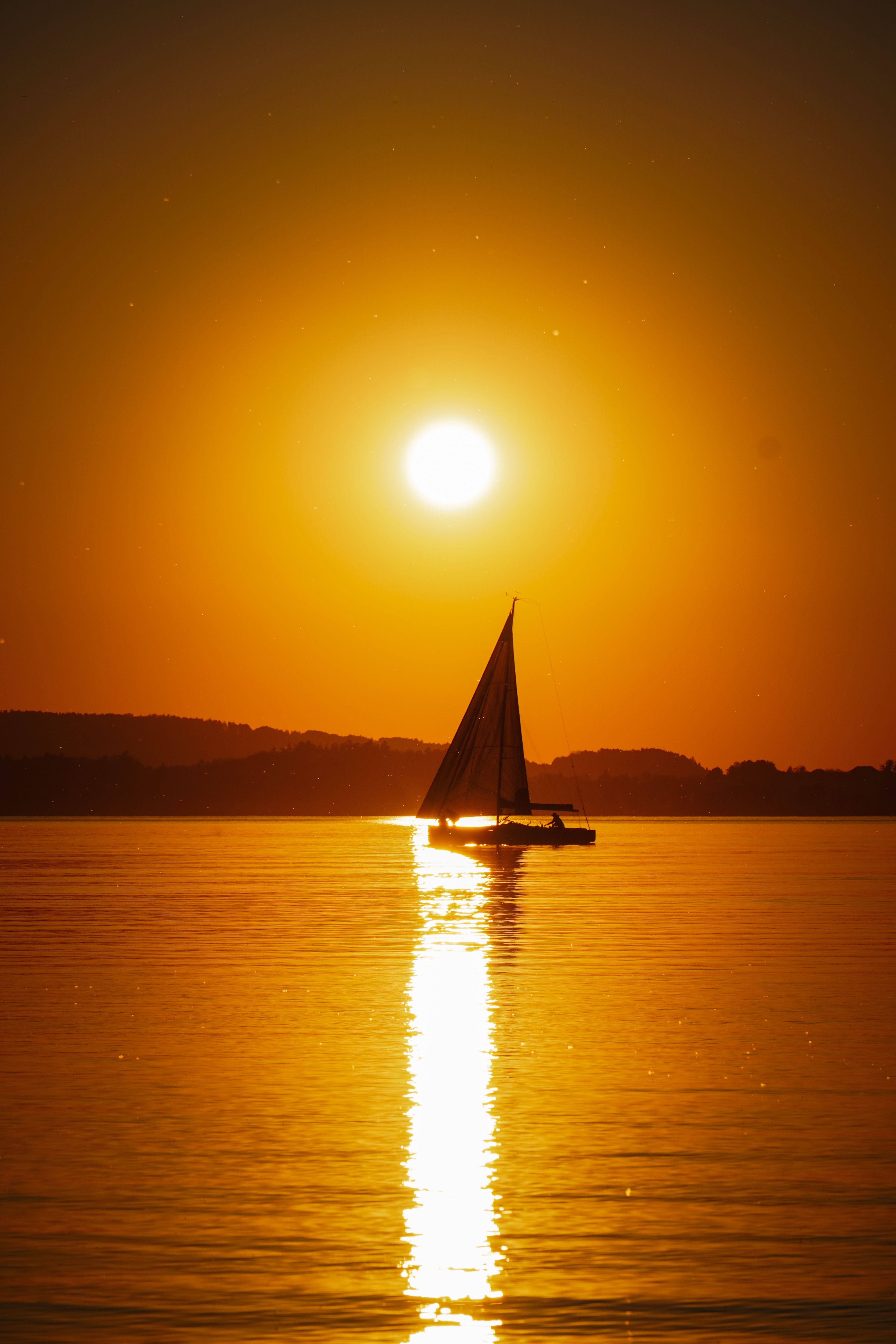 Serene Sailboat at Sunset on Chiemsee Lake · Free Stock Photo