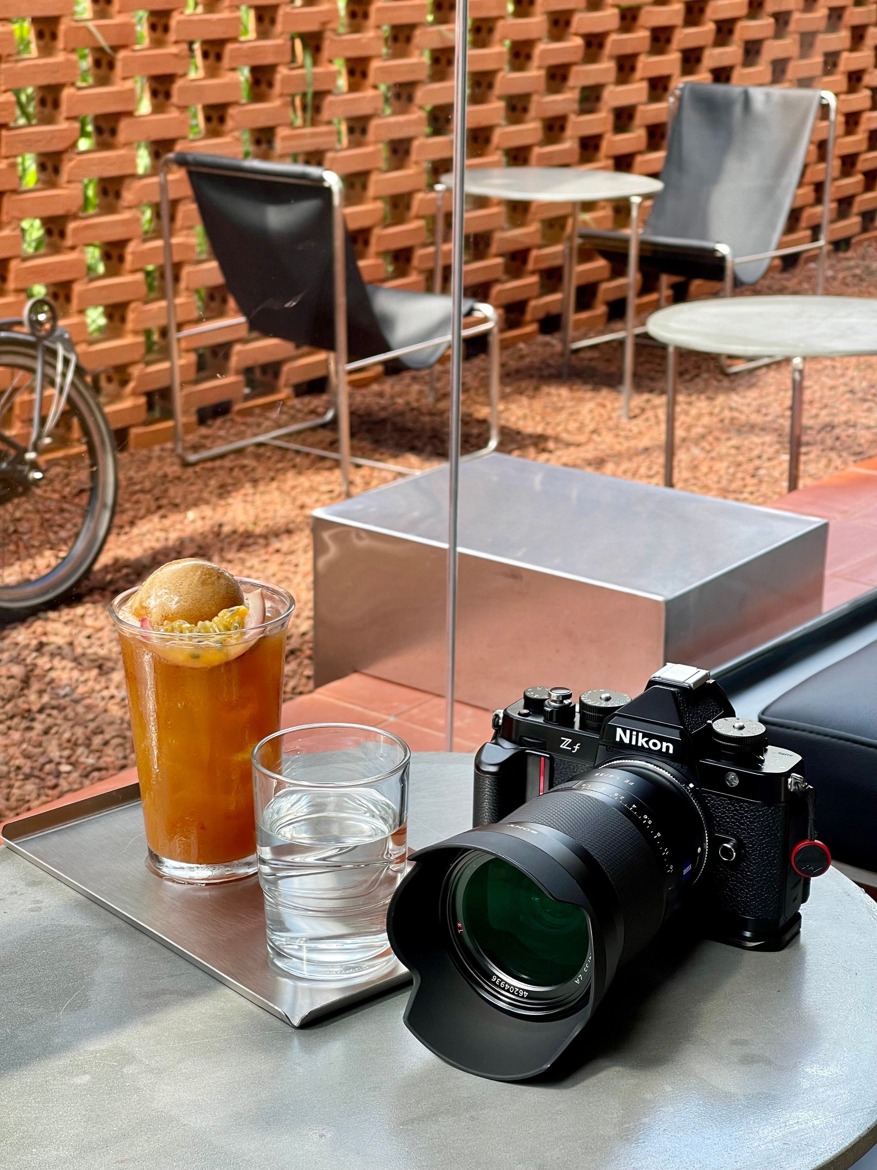 outdoor cafe table with camera and iced coffee