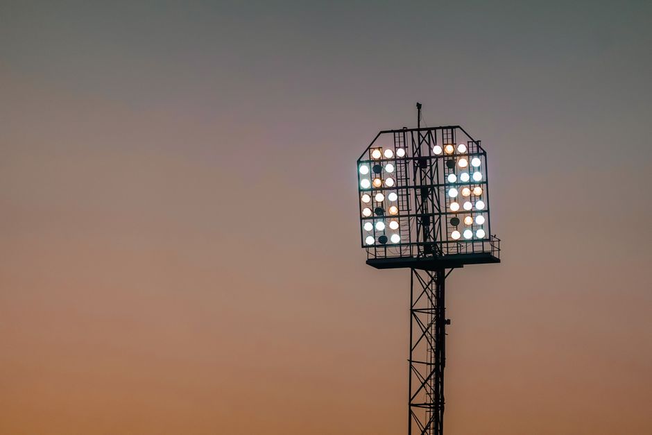 Stadium floodlights against a sunset sky — photo by Magda Ehlers on Pexels