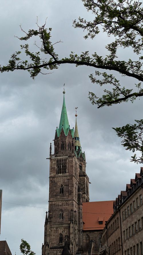 Free A captivating view of St. Sebald Church in Nuremberg, Germany, captured under a moody sky. Stock Photo