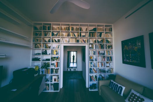 Inviting home library featuring tall bookshelves and cozy seating, perfect for relaxation and reading.