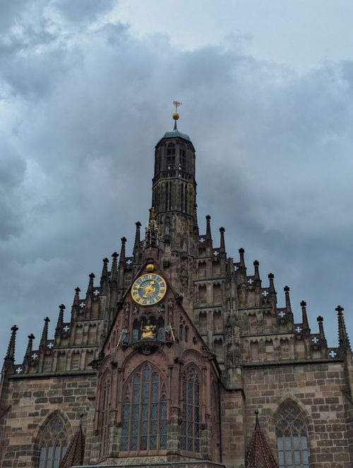 Free View of the Gothic Frauenkirche in Nuremberg, Germany, with overcast skies enhancing its architectural grandeur. Stock Photo
