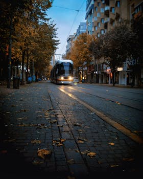 Evening view of a tram moving through Eskişehir, Türkiye during autumn.