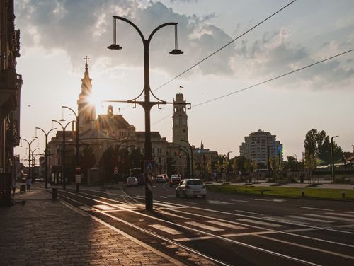 Free Charming sunset over a European city with historic architecture and street lamps casting shadows. Stock Photo