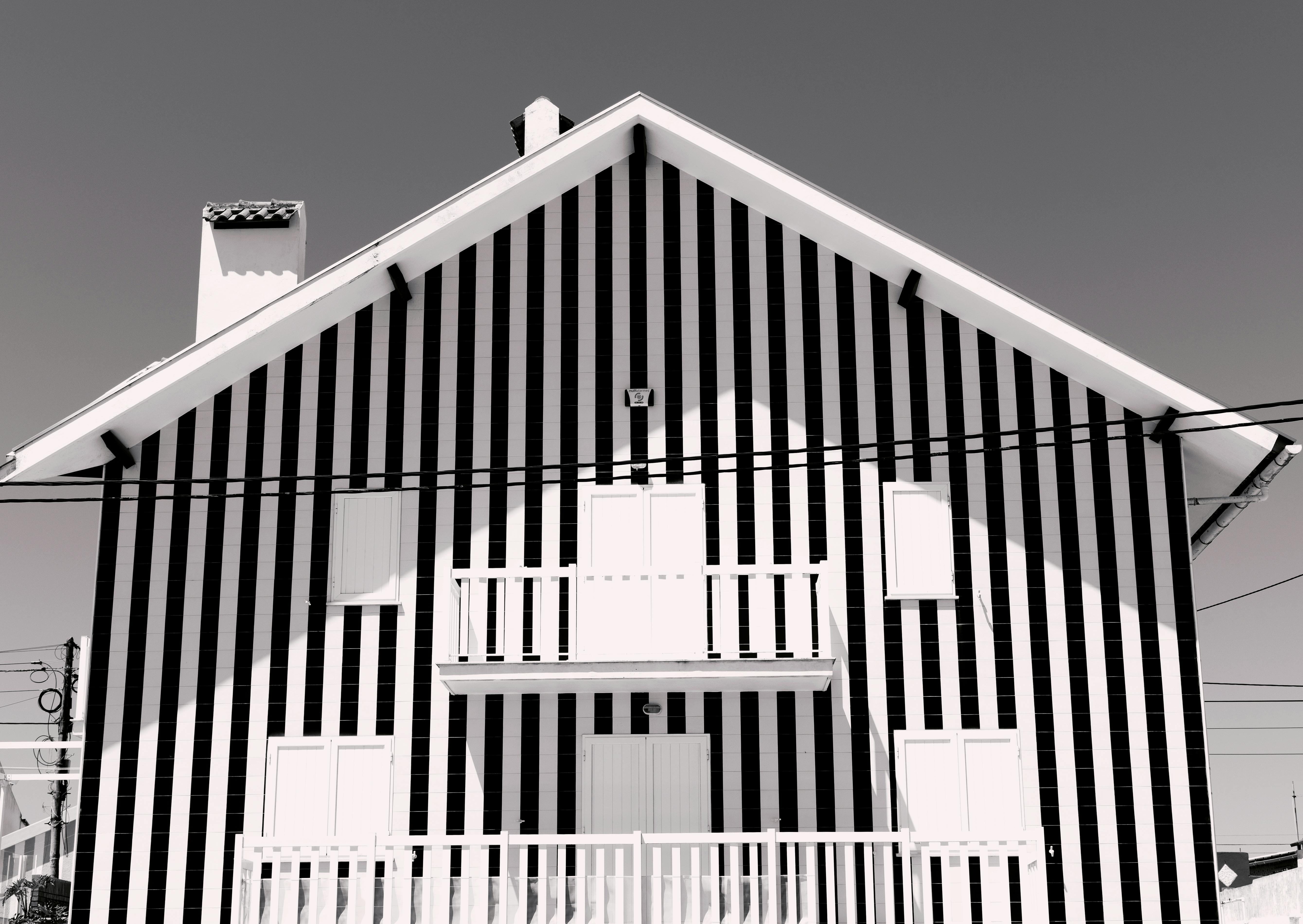 Artistic black and white striped house facade with geometric design.