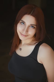 Close-up portrait of a smiling woman with fashionable jewelry in Dubai, showcasing beauty and style.