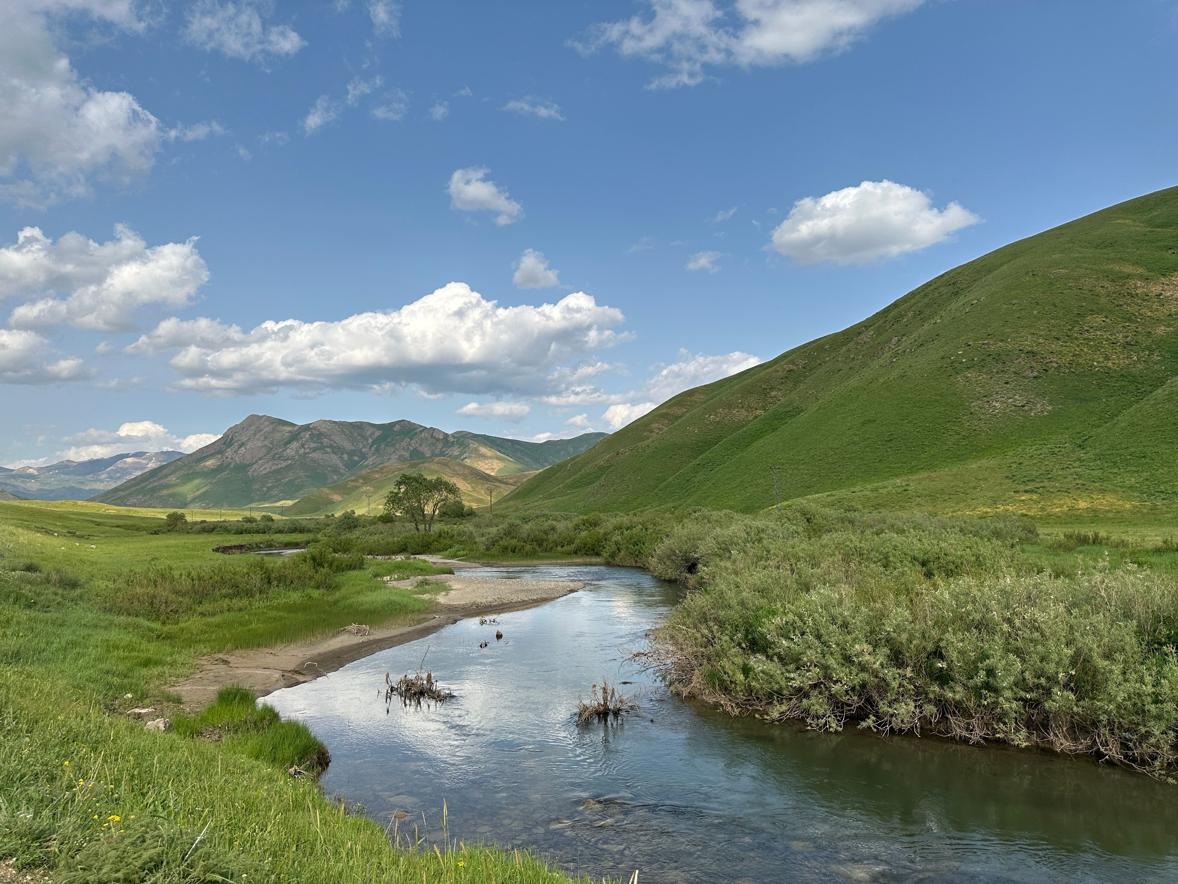 Scenic River and Green Hills in Spring Landscape · Free Stock Photo