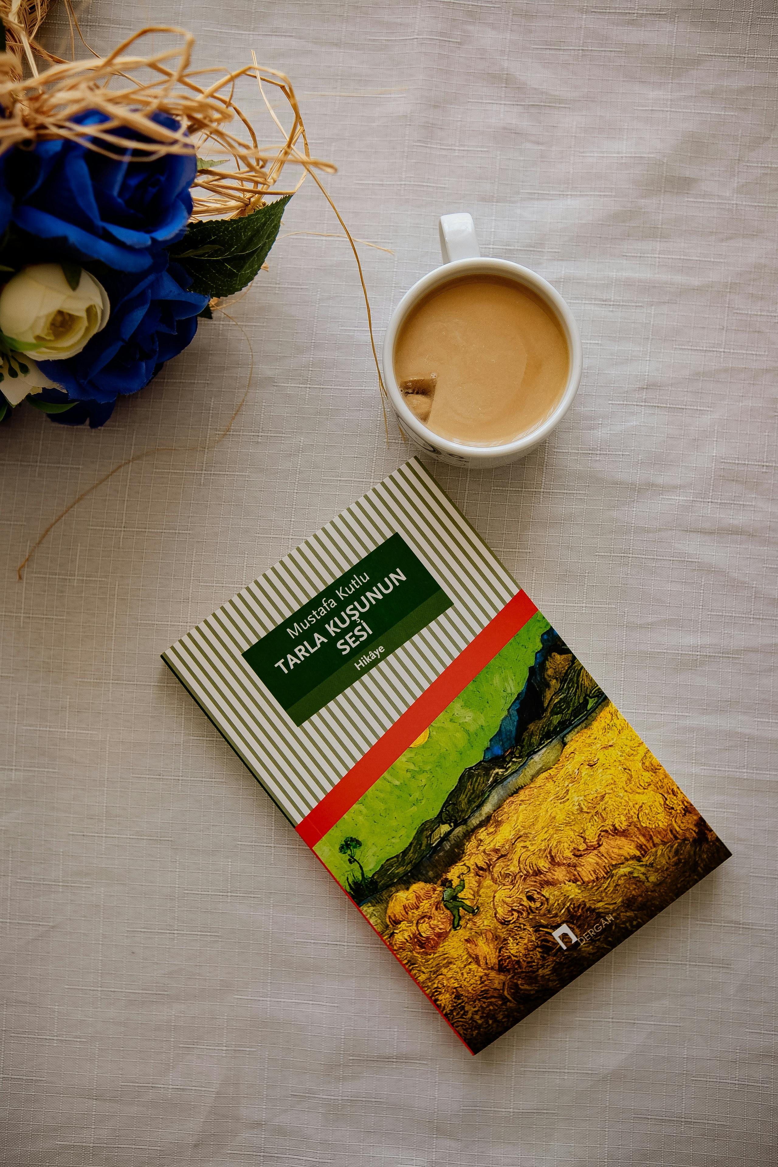 Flat lay of coffee and book creating a cozy reading atmosphere.