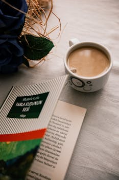 Warm coffee next to an open book on a cozy table setting, exuding relaxation.