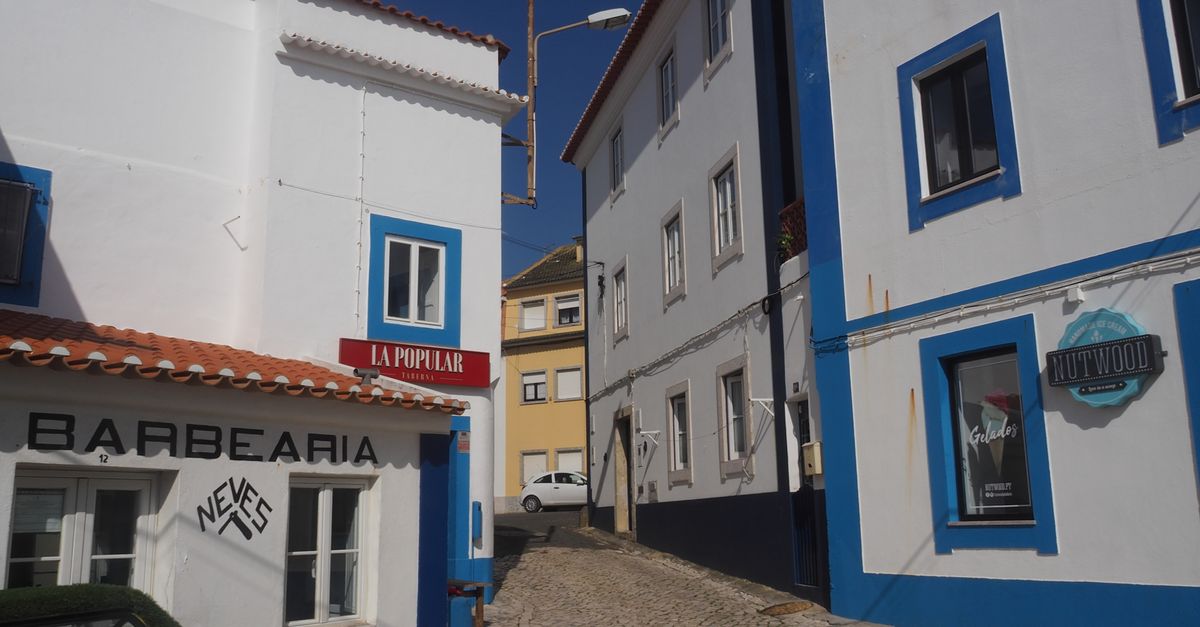 Historic street in Ericeira, Portugal, showcasing traditional Portuguese architecture.