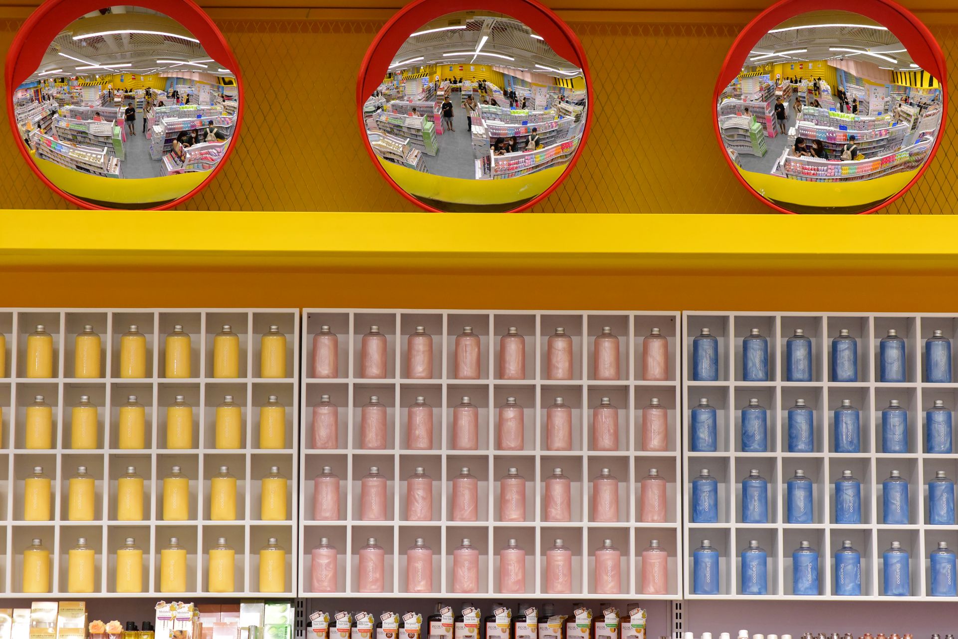 Vibrant warehouse scene with colorful shelves and circular mirrors, capturing a busy shopping environment.