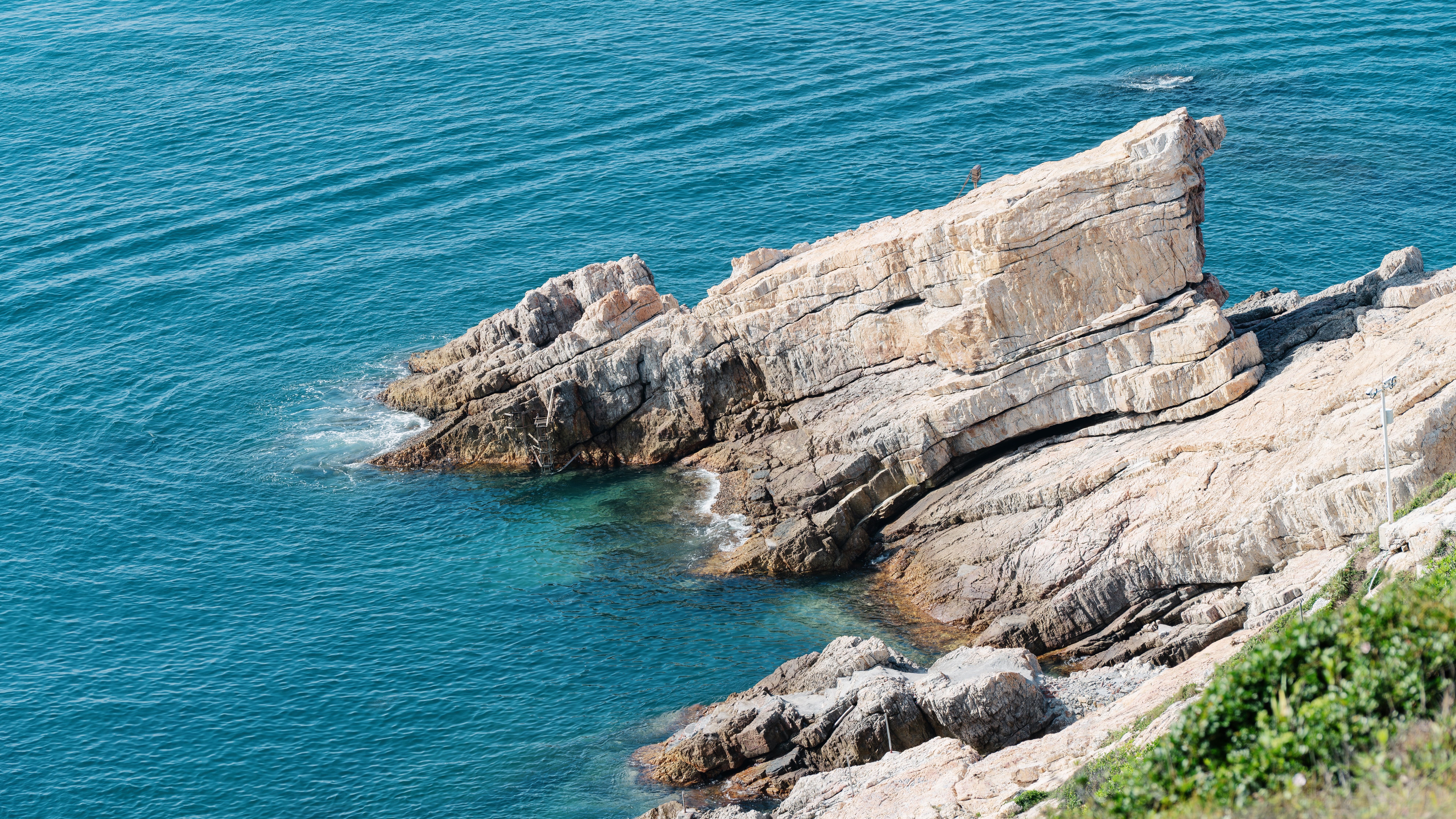 Majestic Coastal Rock Formation in Clear Blue Sea · Free Stock Photo