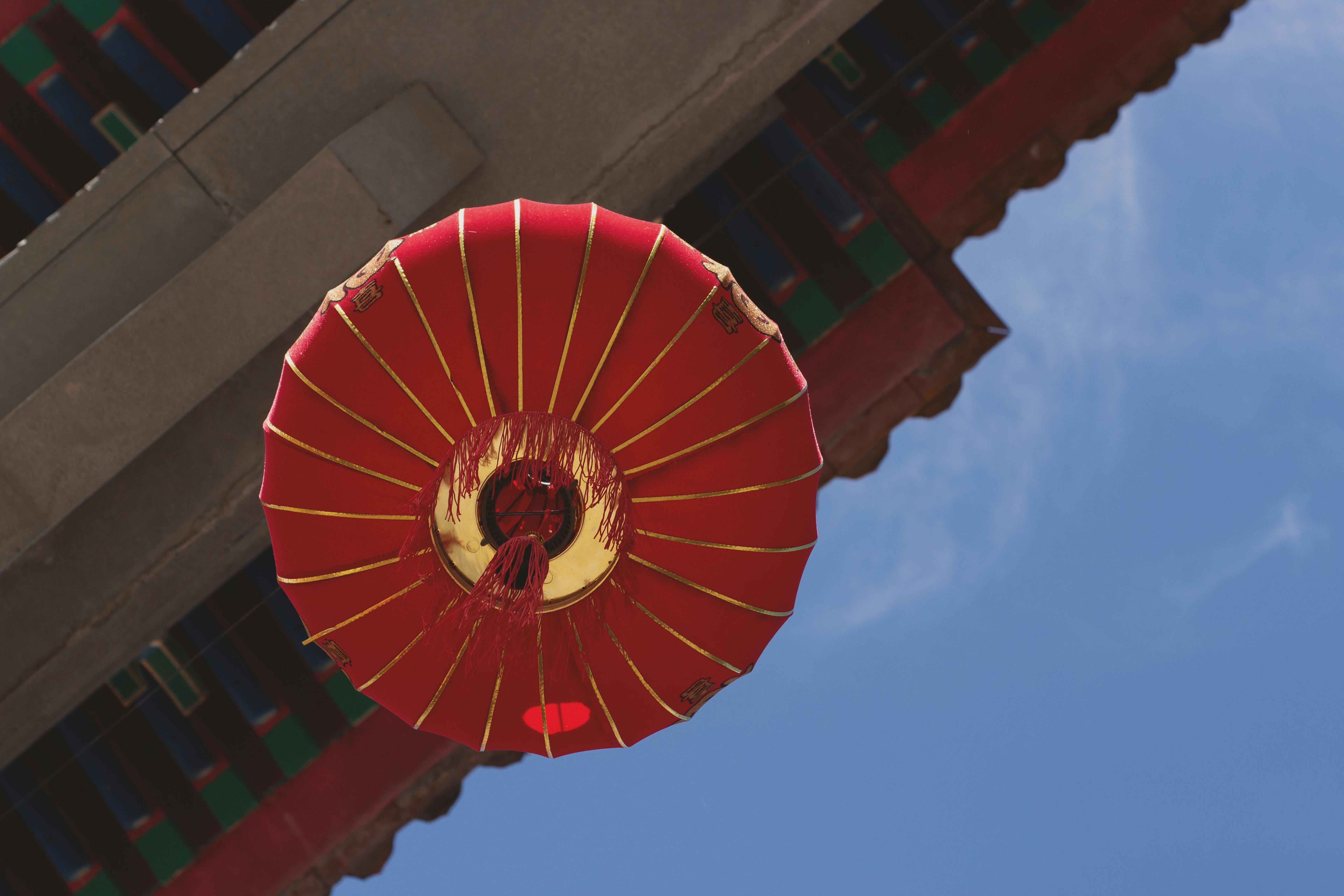 Red decorative lantern in Buenos Aires Chinatown against a clear blue sky, showing cultural diversity.