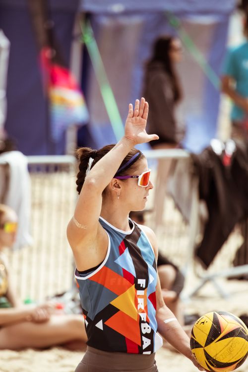 Free Athlete poised for a volleyball serve on a sunny beach in England. Stock Photo