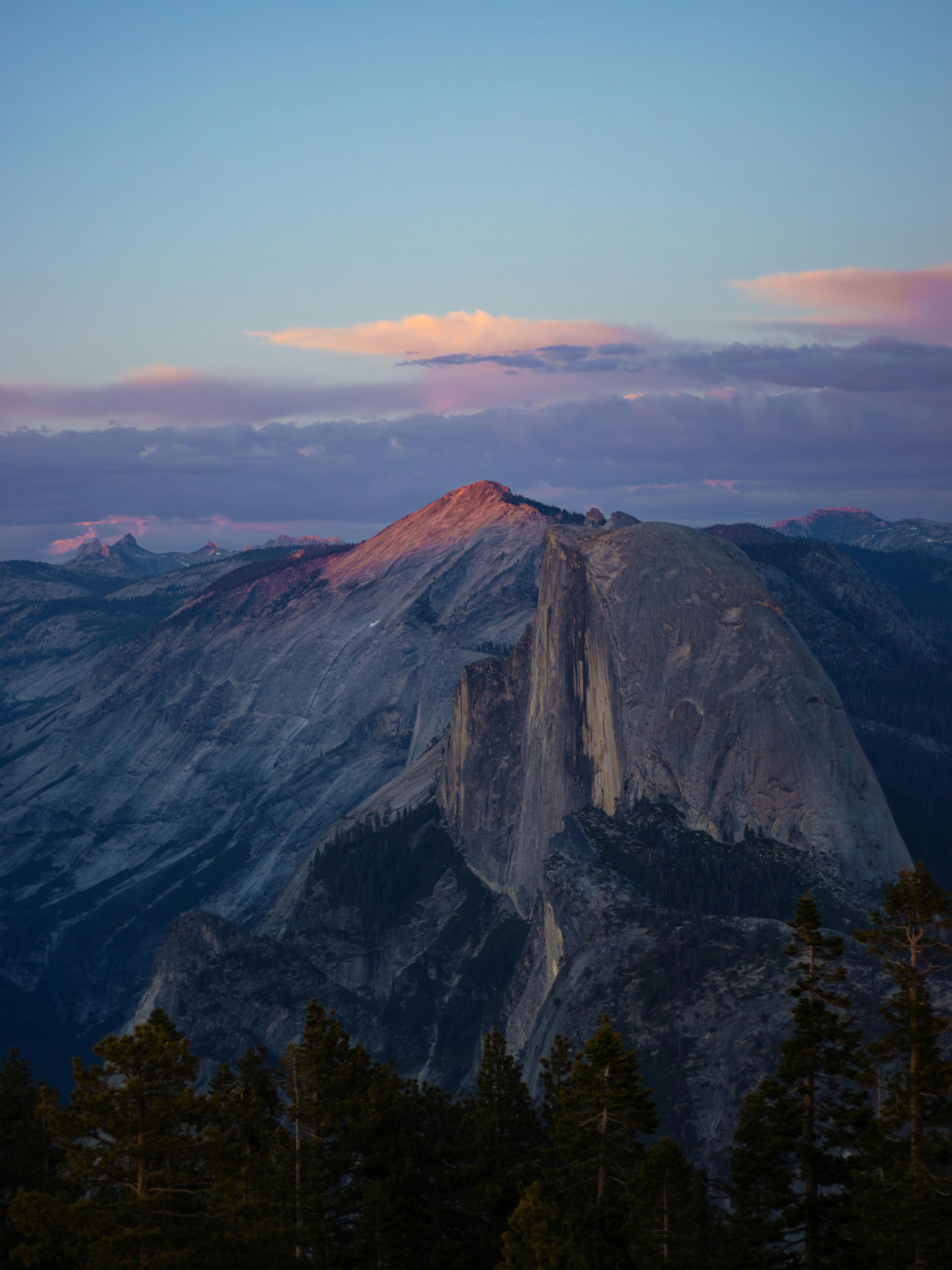Majestic view of Half Dome bathed in sunset hues from Yosemite National Park in California, USA.
