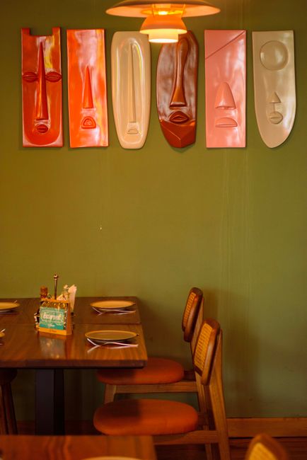 Warm and inviting restaurant interior in Accra with abstract wall art.