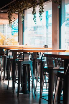 A vibrant and modern cafe setting featuring high stools and large windows in Accra, Ghana.
