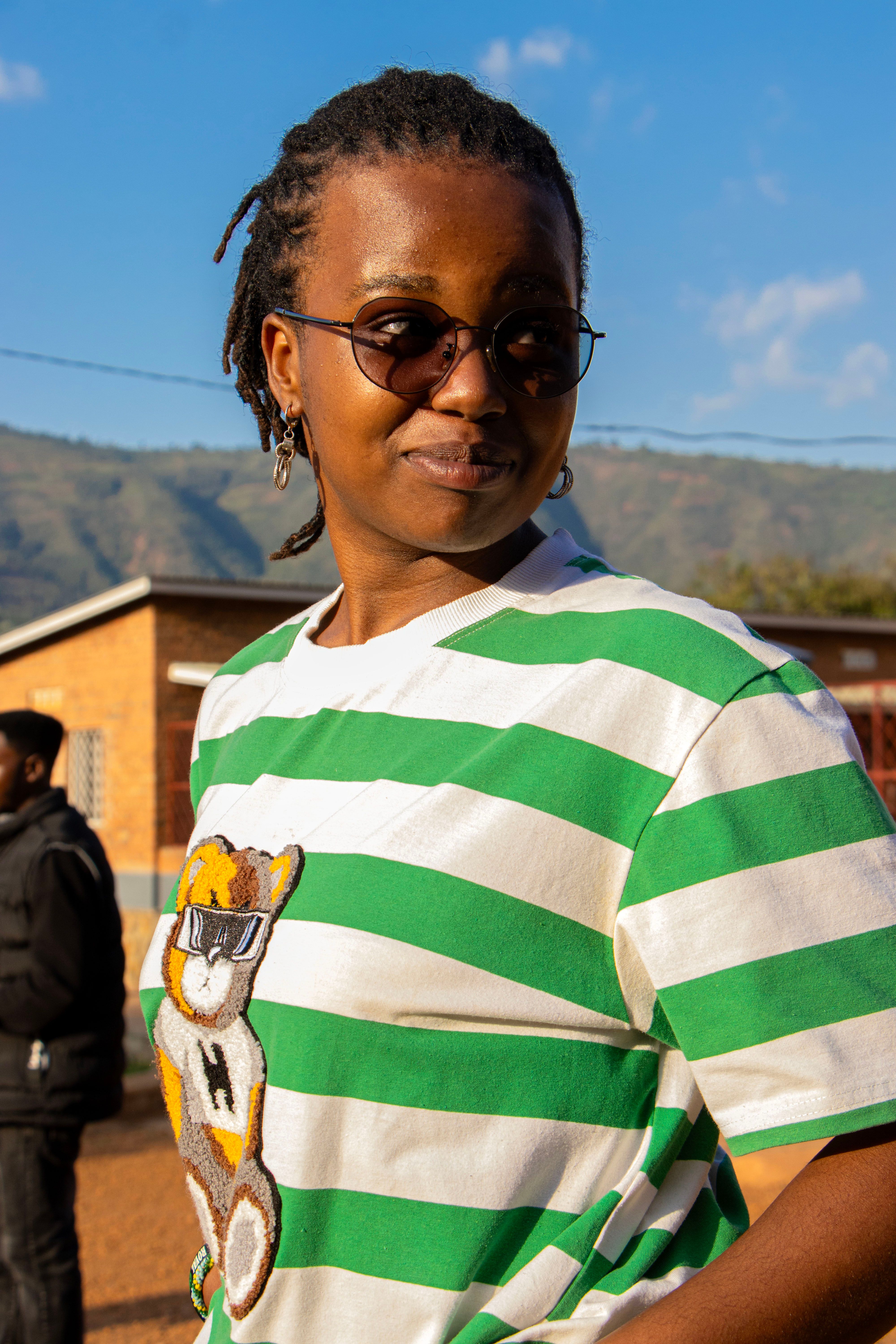 Smiling Woman in Striped Shirt Outdoors · Free Stock Photo