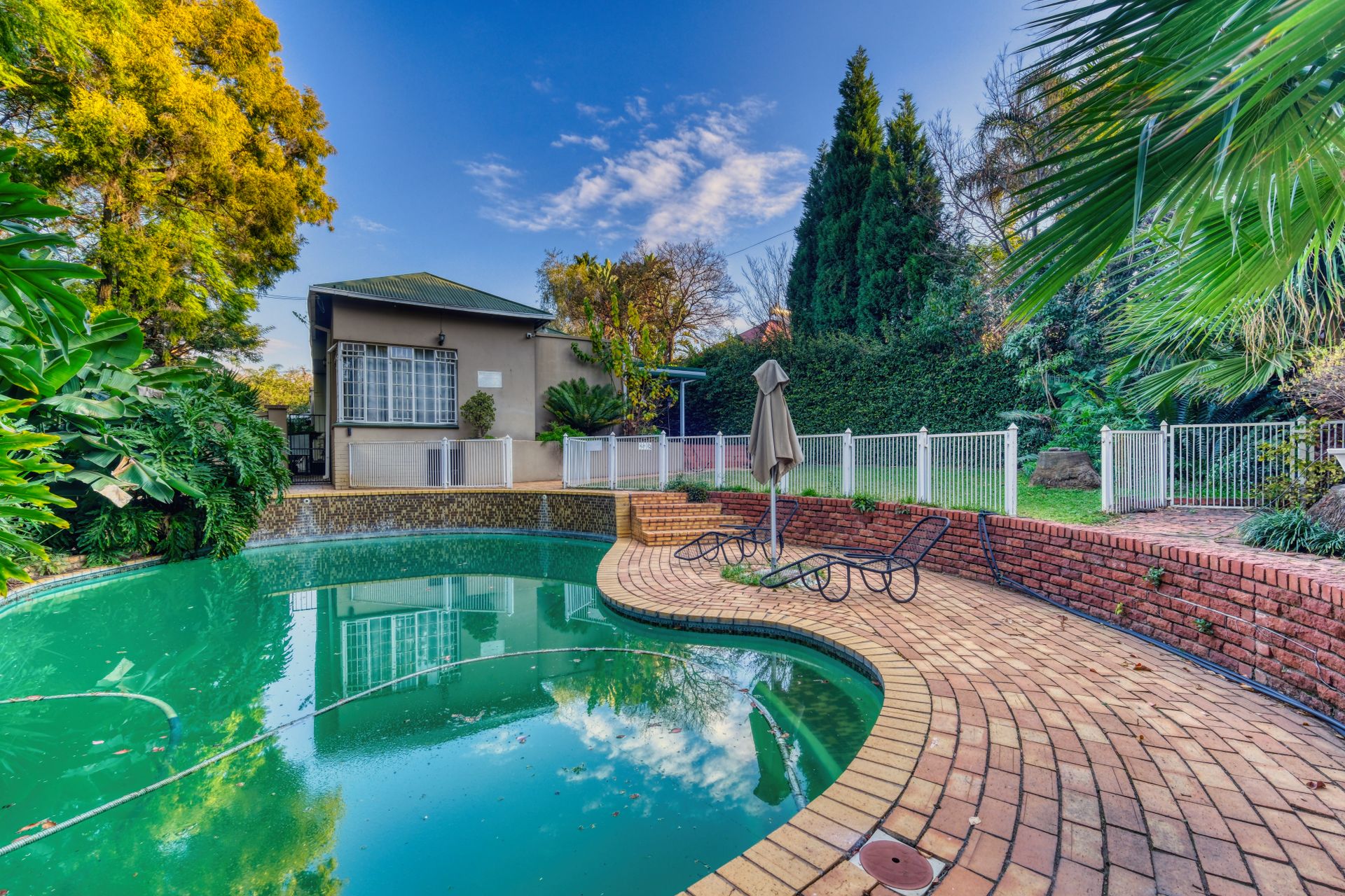 Elegant backyard pool area in Pretoria, South Africa. Perfect for home and real estate themes.