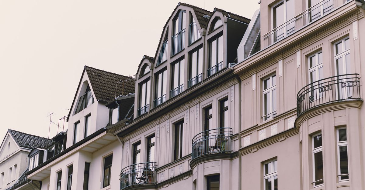 Elegant European townhouse facades with decorative balconies and classic architecture.