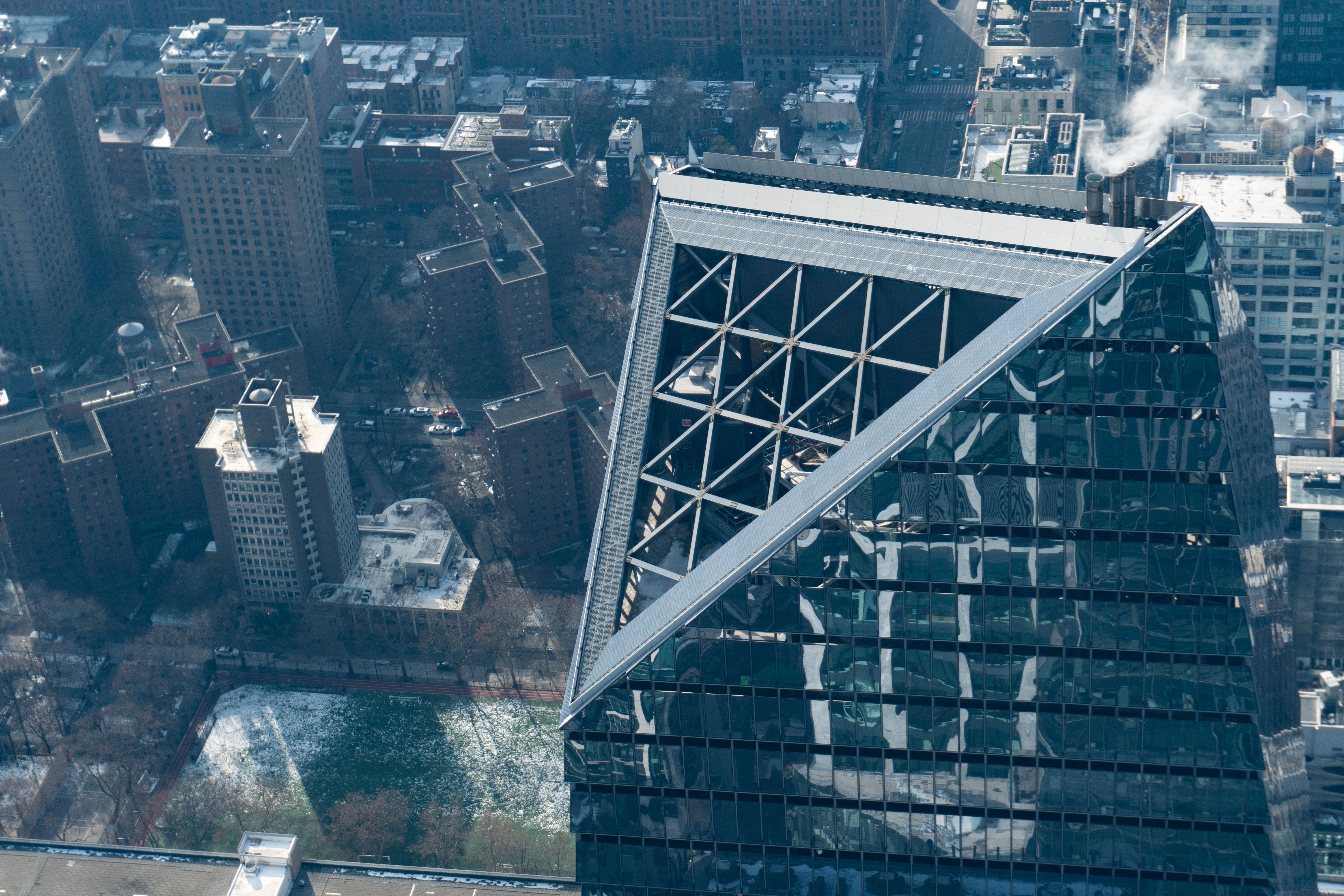 Stunning aerial shot of a skyscraper and surrounding buildings in New York City.