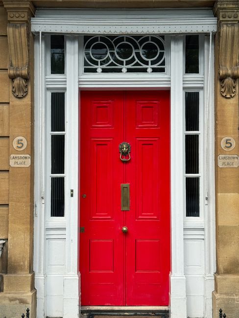 Stately red door set in classic English architecture, Lansdown Place, England.