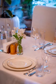 A well-arranged table setting in a Mtskheta restaurant featuring fine dinnerware and floral centerpiece.